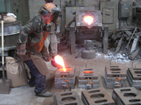 Fence -- Swiss Foundry -- pouring metal into molds for fence elements.
