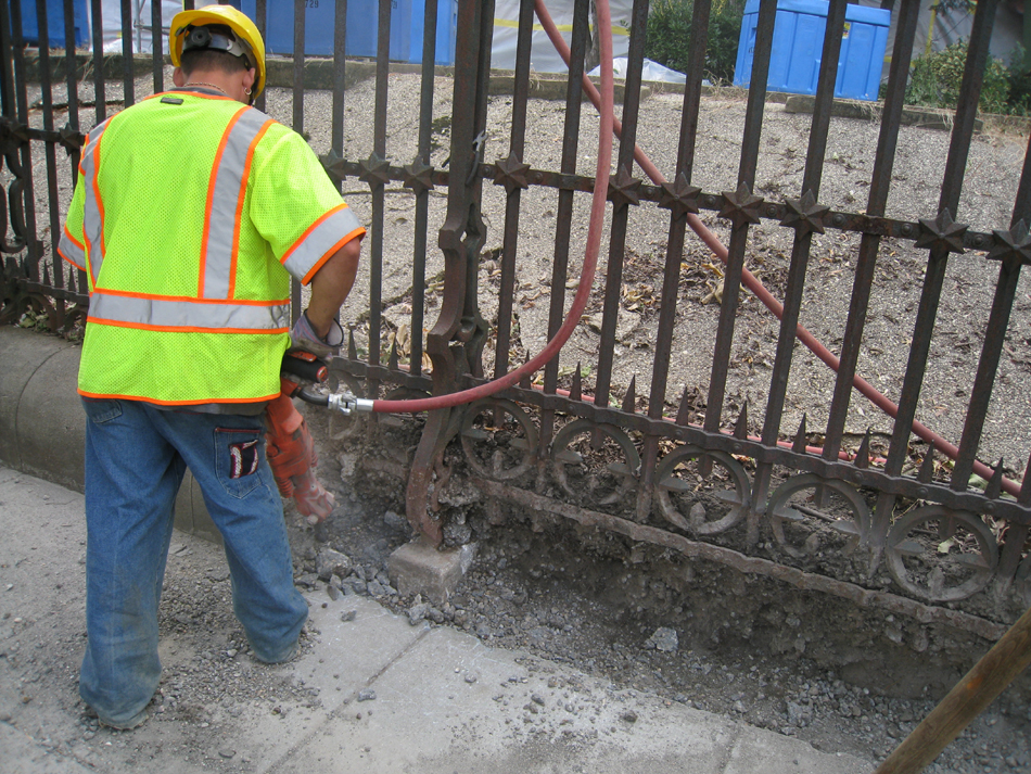 Fence--Removal of cement from bottom of fence on Pennsylvania Ave. side