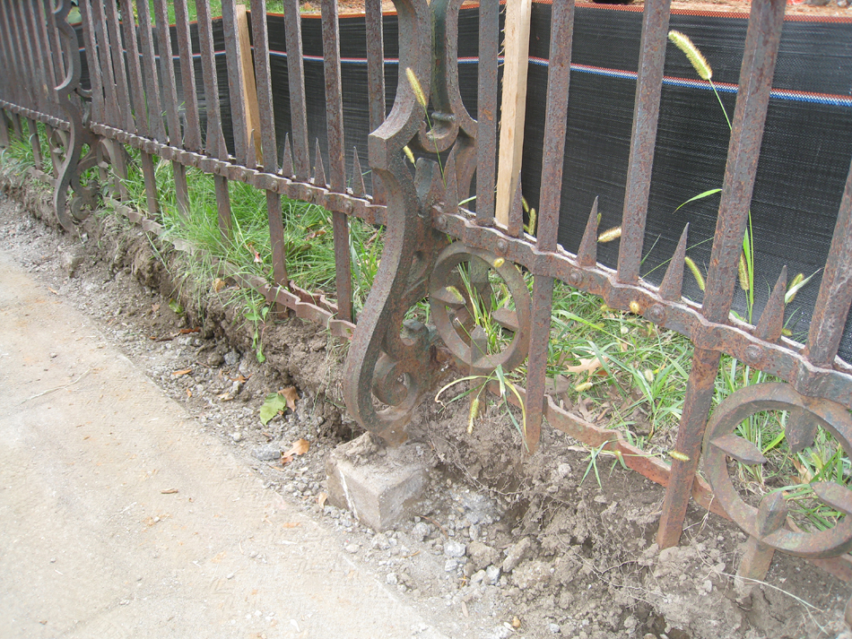 Fence--Detail--Removal of cement from bottom of fence on Pennsylvania Ave. side