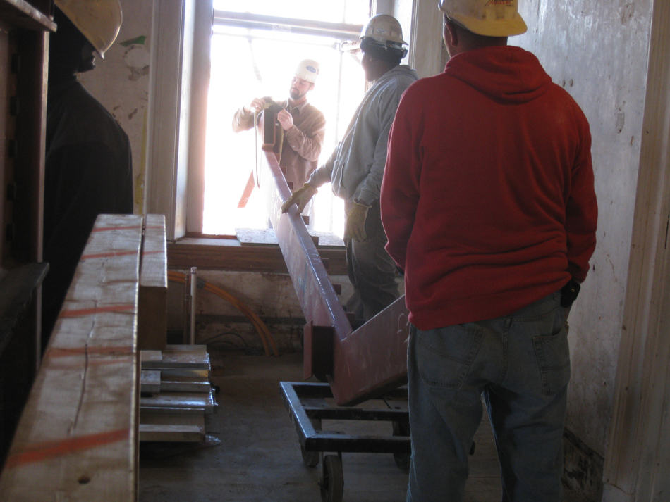 Second Floor--Lifting the parts for the east staircase into the building (through the west side corridor window)