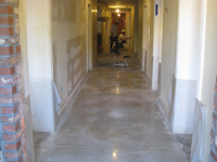 Ground Floor (Basement) --Workers polishing the concrete corridor floor - April 29, 2011