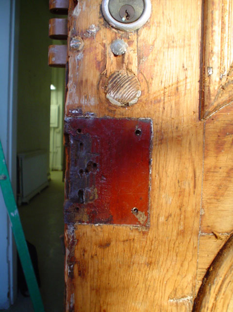 The original color of the doors was found under some of the hardware. It is a beautiful barn red with a surface so smooth as to look like metal.