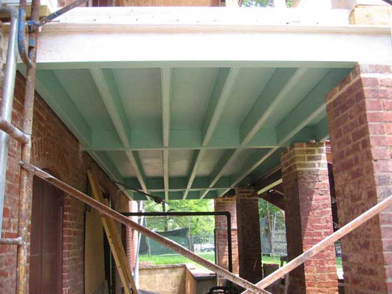 A tinted primer was applied to the underside of the repaired portico floor and frame.